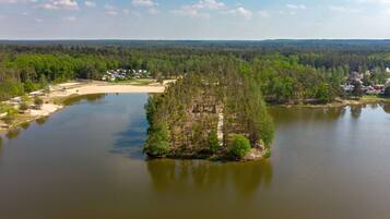 An aerial view of a lake with a small island in the center.
