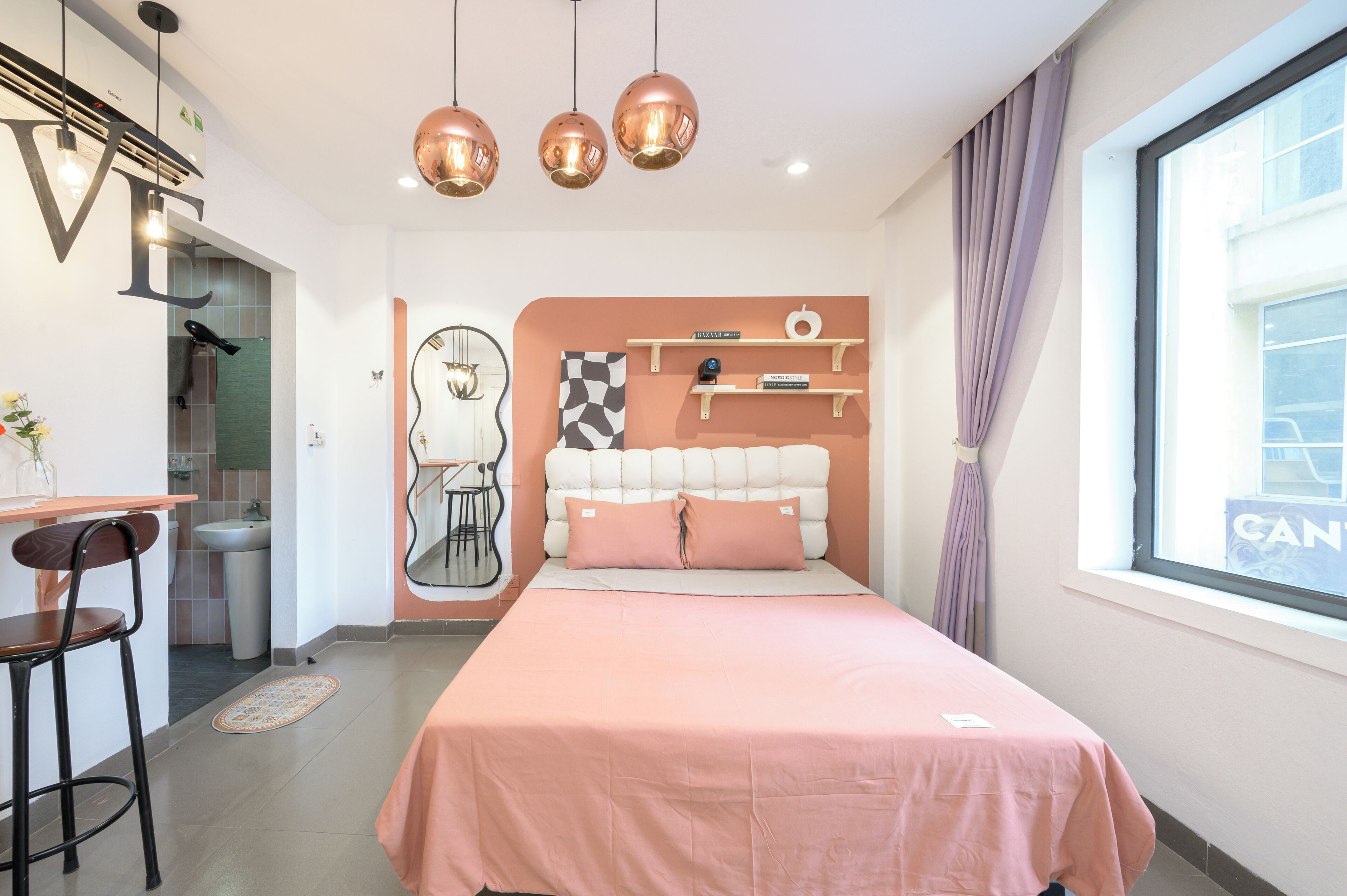 A modern bedroom with a bed, a desk, and a chair.