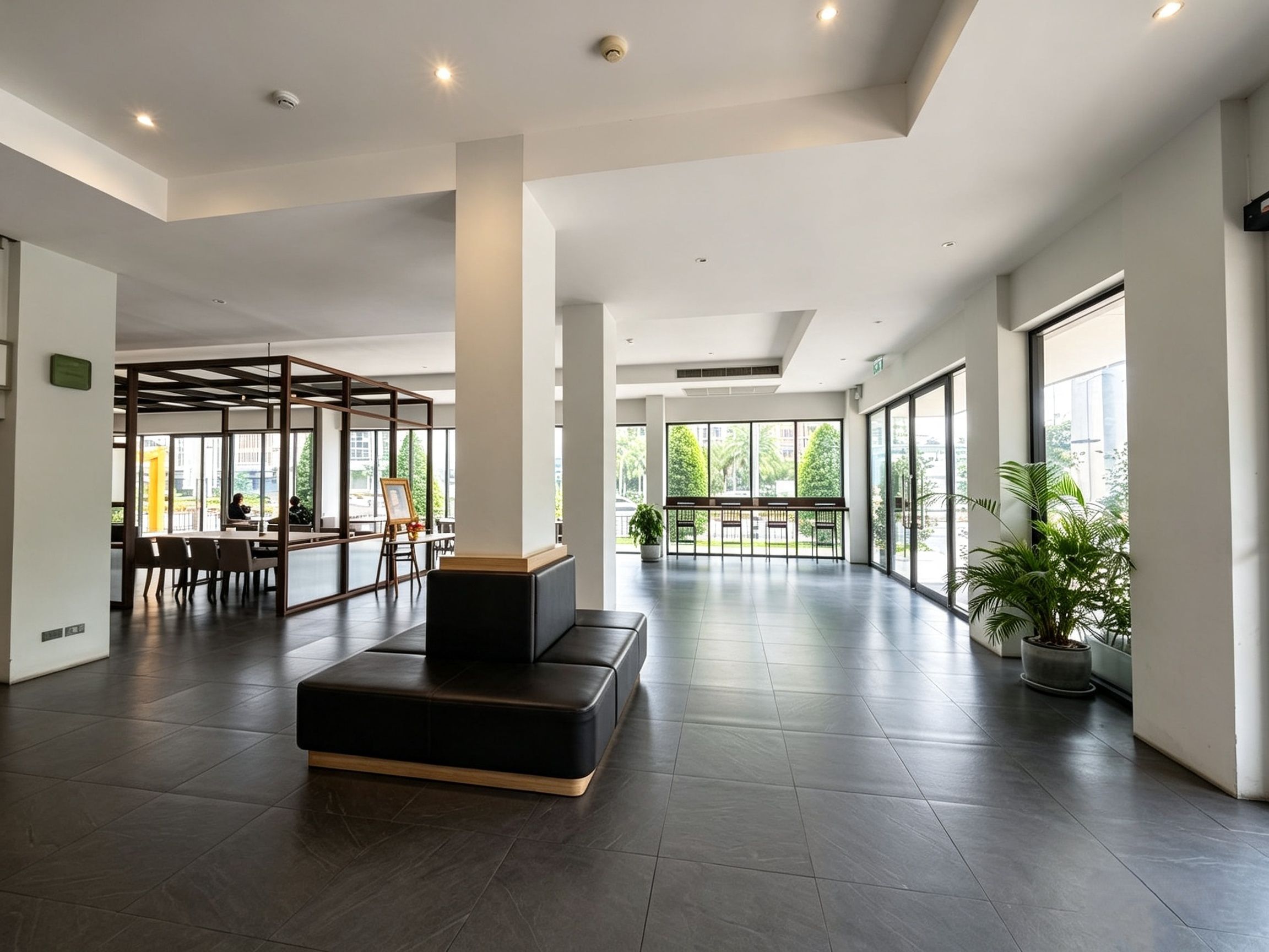 A spacious lobby with a central seating area, large windows, and a modern design.