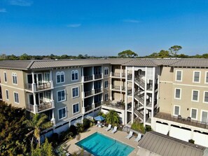 A multi-story hotel with a pool, balconies, and a central staircase. - One bedroom with Oceanviews! (Saint Simons Island)