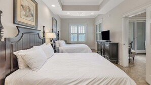 A hotel room with two beds, a TV, a desk, and a window. - One Bedroom just across the street from the Beach! (Saint Simons Island)