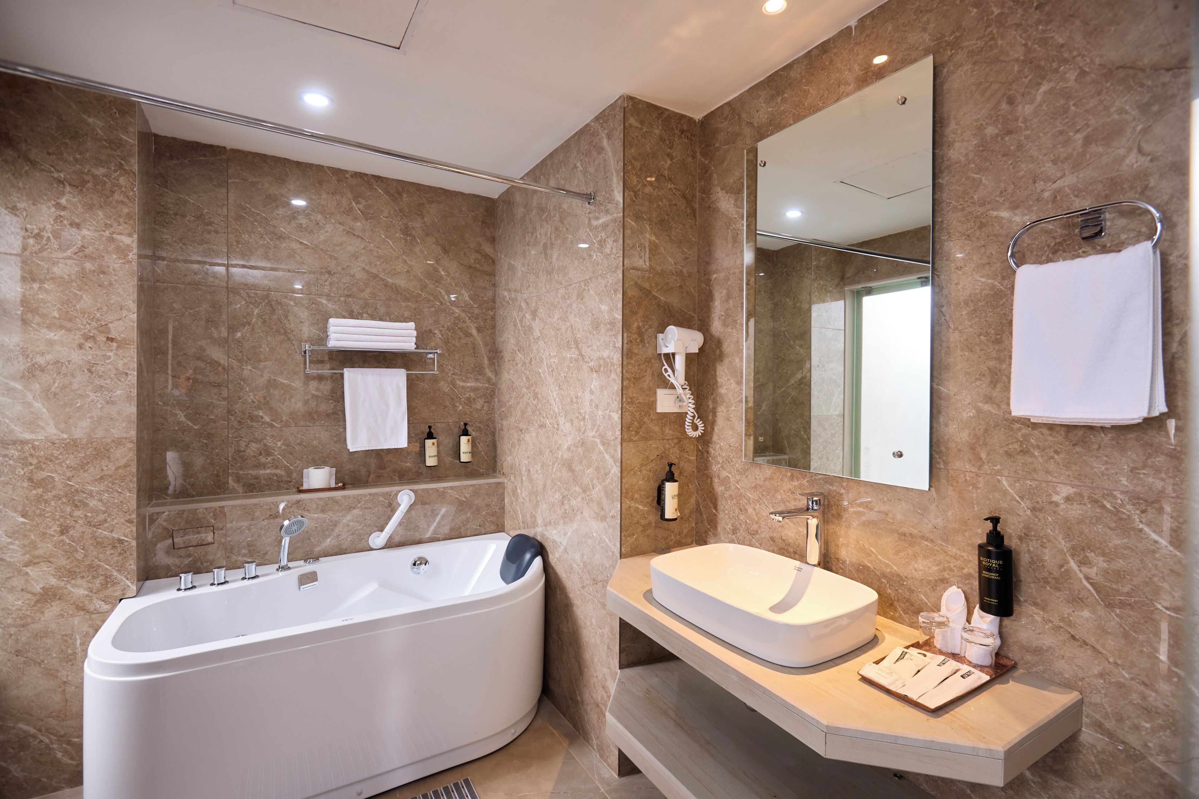 Un bagno moderno con una vasca freestanding, un mobile lavabo e un grande specchio.
