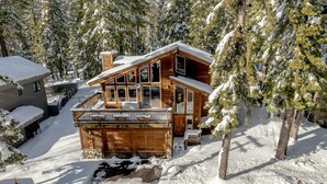 A log cabin with a balcony, surrounded by snow-covered trees. - Walk to Beach & Ski, 4BR Custom Tahoe Home (Tahoe City)