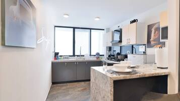 Fridge, stovetop, dishwasher, coffee/tea maker