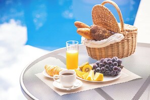 Enjoy a leisurely breakfast by the pool with a serene view.