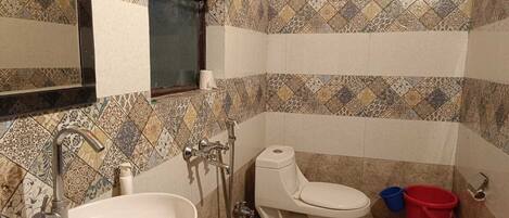 A bathroom with a sink, toilet, and shower.