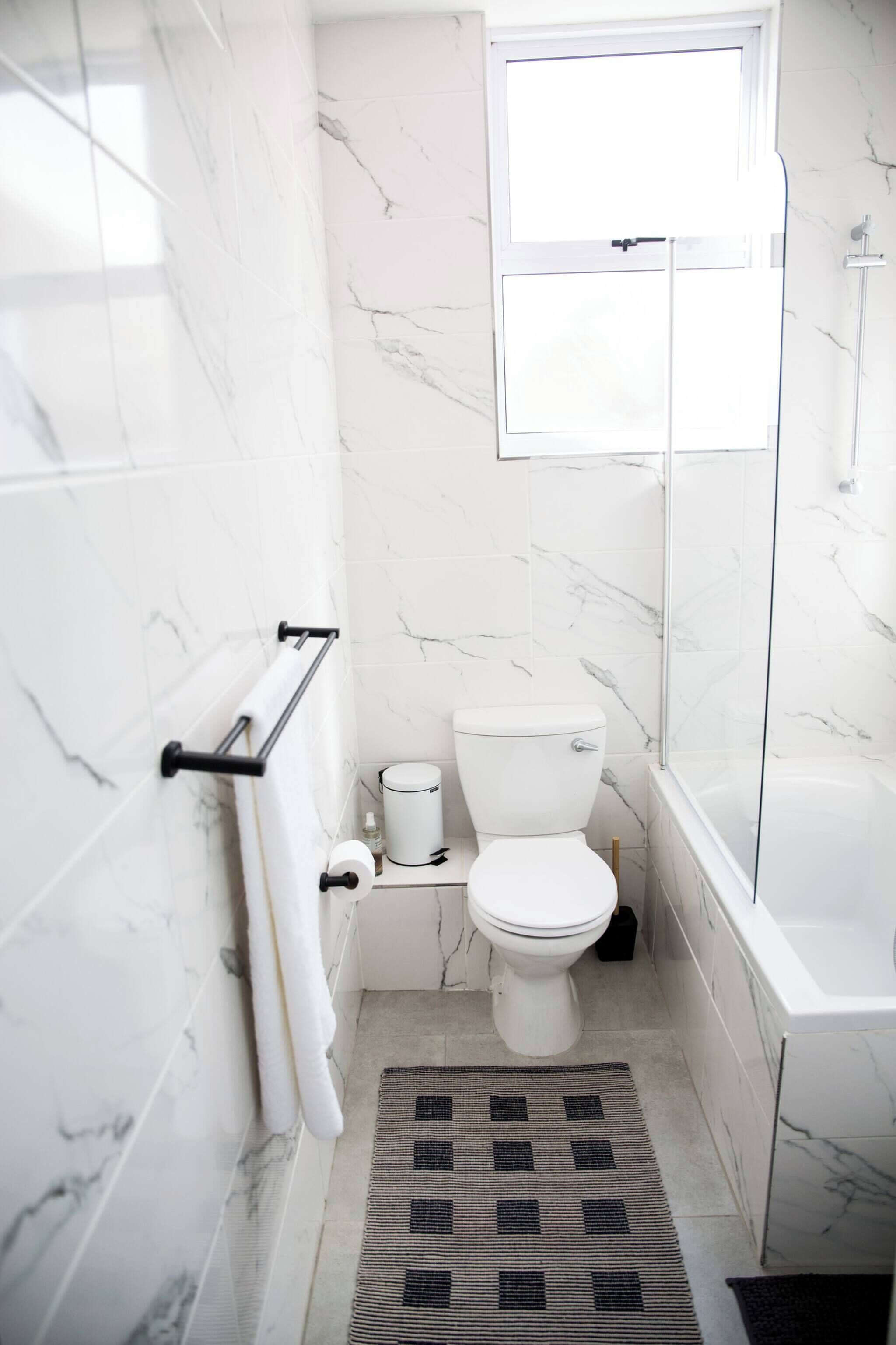 Et moderne badeværelse med toilet, bidet og badekar.