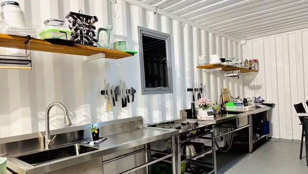 A modern kitchen with stainless steel appliances, wooden shelves, and a window. - Ataahua HighlandA little slice of Paradise- Off Grid retreat. (Te Kopuru)