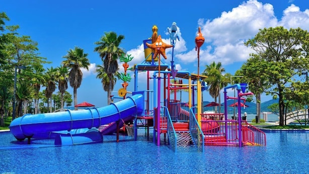 A water park with a blue slide, a red climbing structure, and a starfish-shaped play area. - Huizhou Hazens East Resort (Huizhou)
