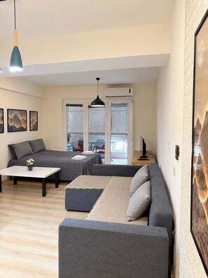 A modern living room with a sofa, a coffee table, and artwork on the wall. - Your Cozy Home by Ohrid Lake (Ohrid)