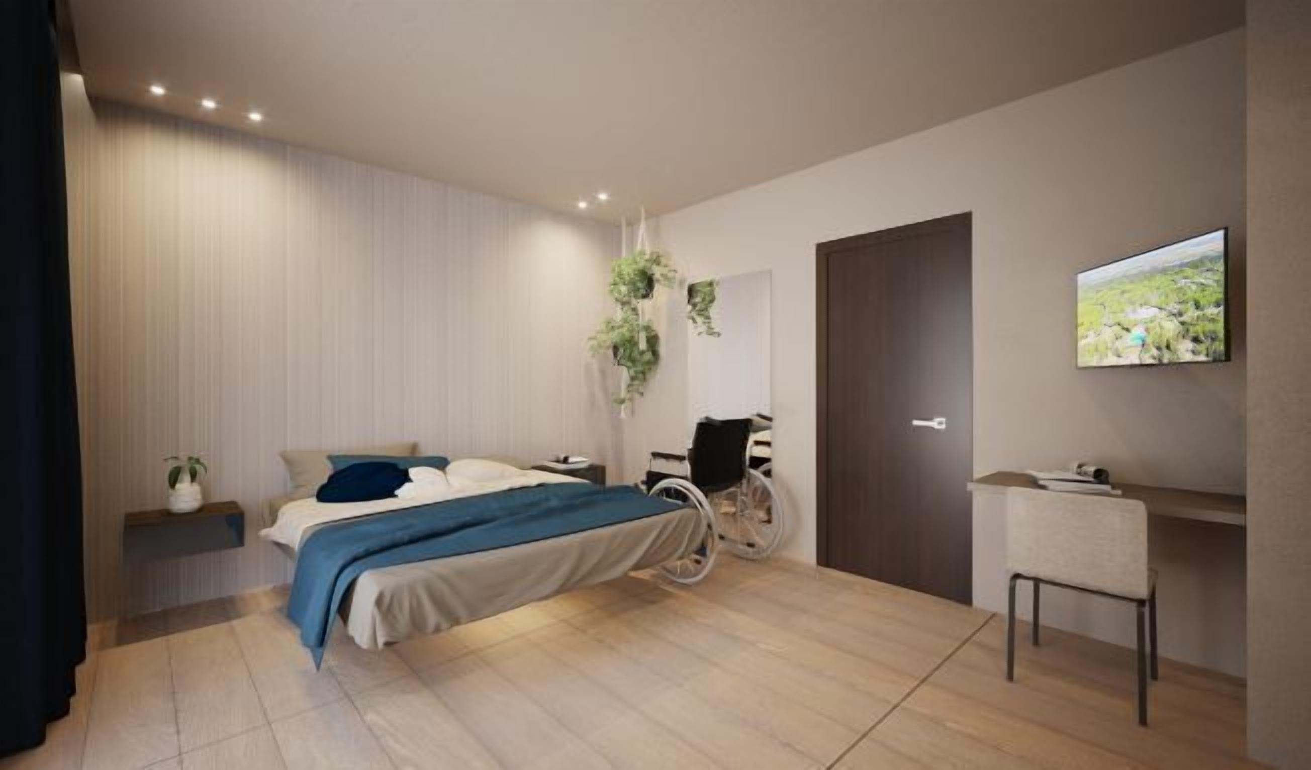 A modern bedroom with a bed, bedside table, chair, and a TV on the wall.