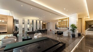 A modern lobby with a pool table, seating area, and a reception desk. - Chengdu Hazens Hotel (Chengdu)