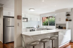 Microwave, dishwasher, high chair, dining tables