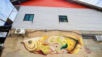 A building with a mural of a fish on its side.