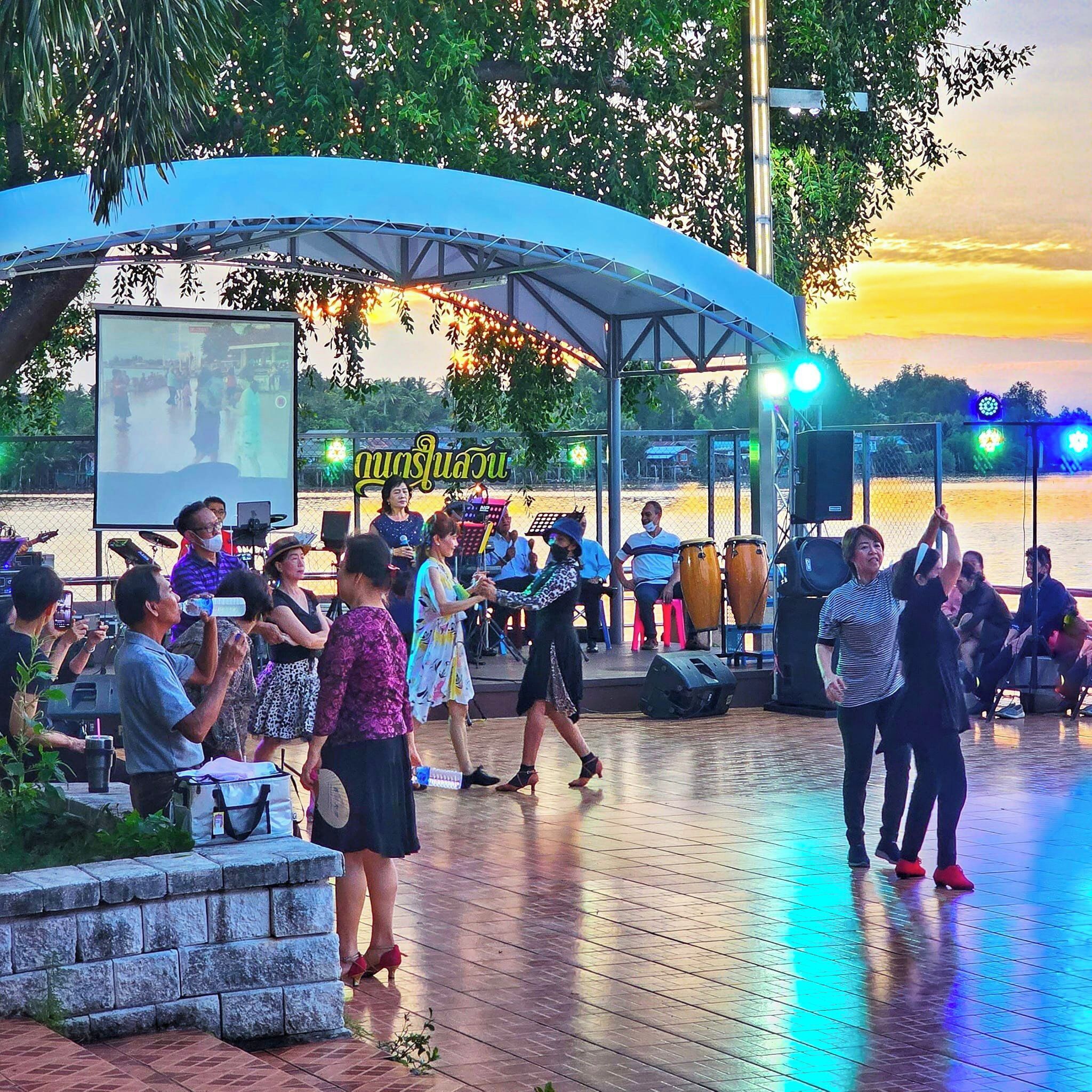 An outdoor event with a stage and audience.