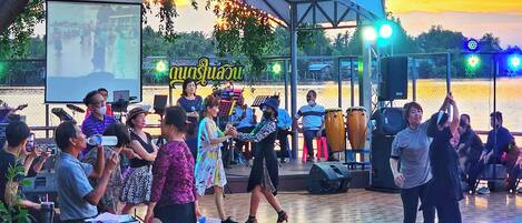 An outdoor event with a stage and audience.
