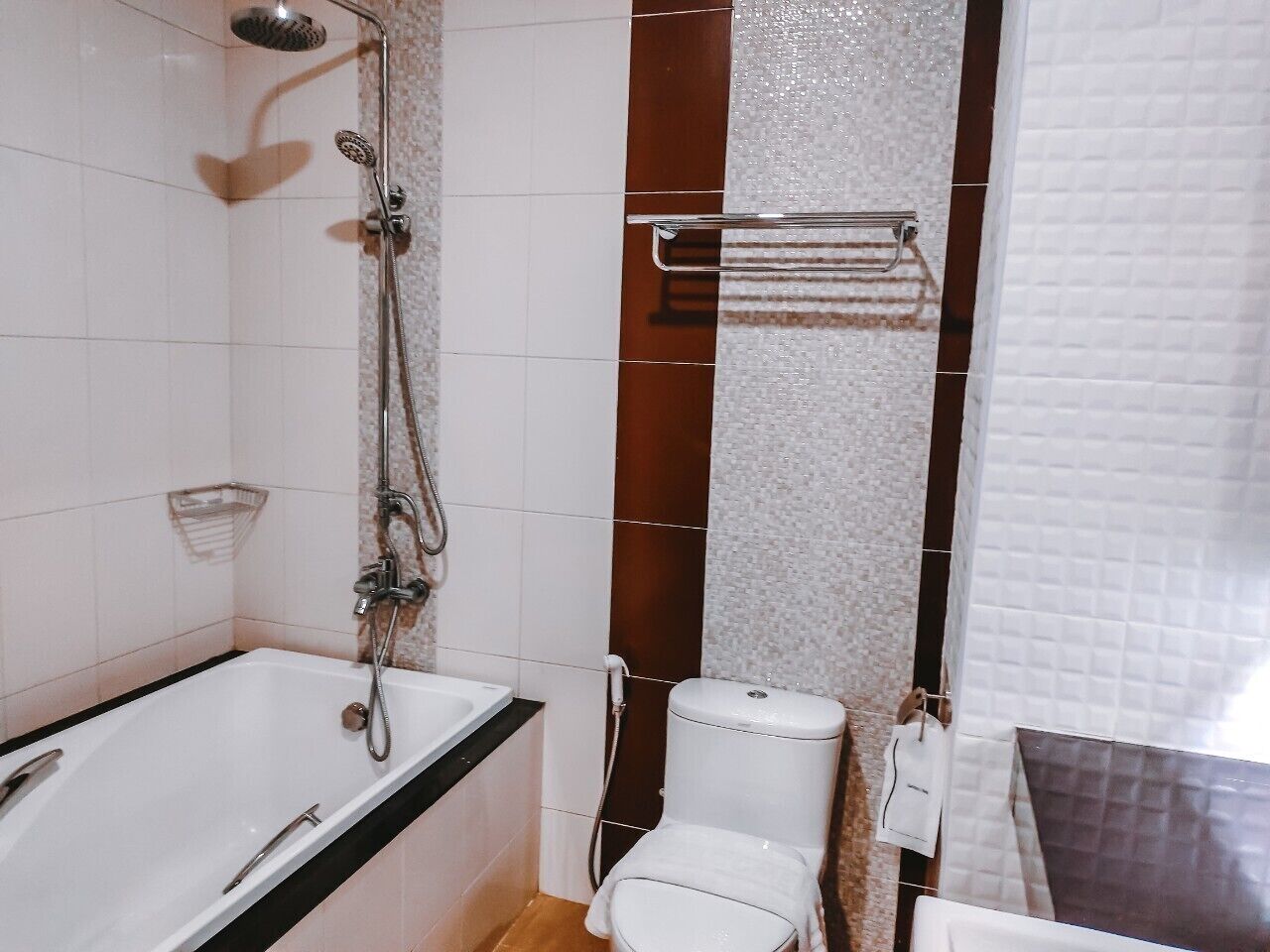 A bathroom with a bathtub, toilet, and shower.