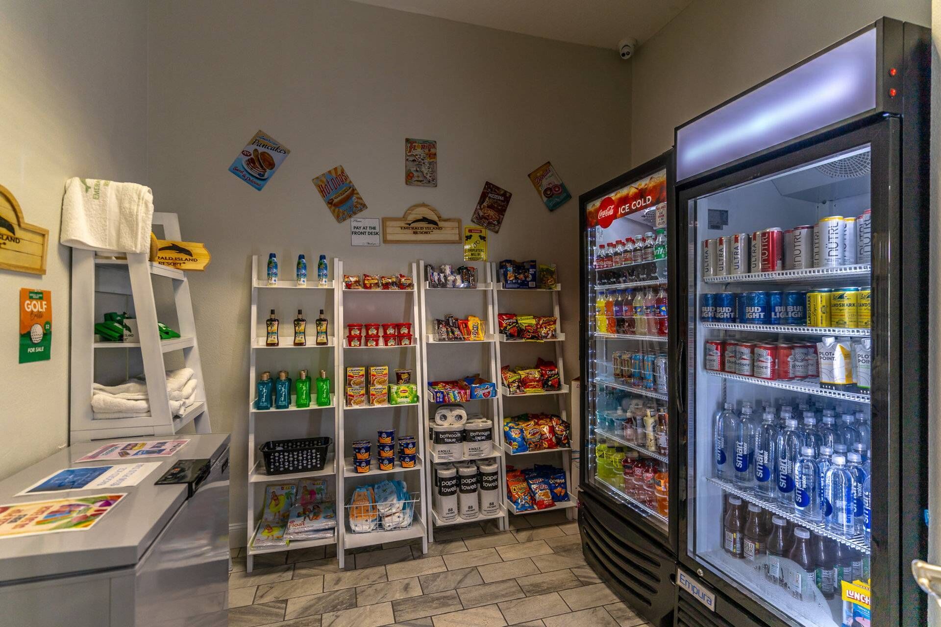 A convenience store with shelves stocked with snacks, beverages, and toiletries.