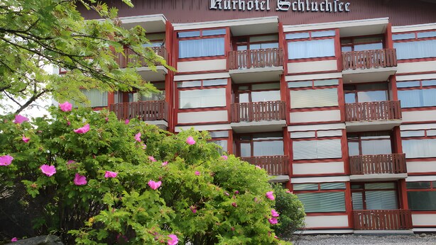 Un edificio de varios pisos con balcones, identificado como 'Kurhotel Schluchsee'.