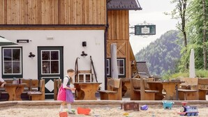 A rustic wooden building with a sign reading "Zloam Hof".