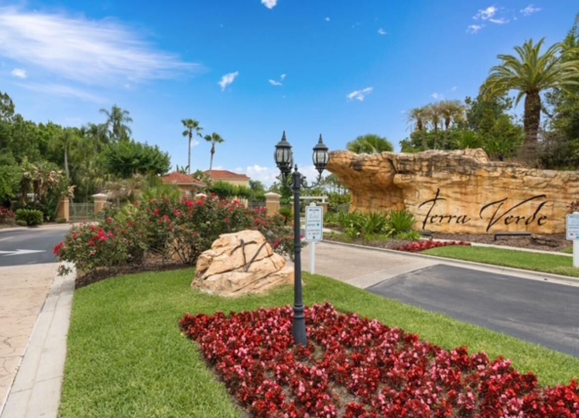 A landscaped area with a rock formation labeled "Terra Verde," a street lamp, and a road.