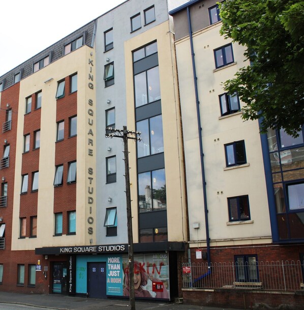 King Square Studios features a unique brick and glass facade, with a commercial space on the ground floor and residential or office spaces above.