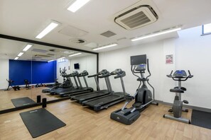 Stay fit on your travels with a fully equipped gym featuring treadmills and a large mirror.