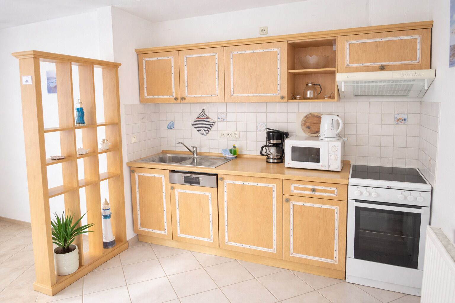 A kitchen with wooden cabinets, a microwave, a coffee maker, a stove, and a dishwasher.
