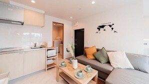A modern apartment with a kitchen, dining area, and living room. - SAIEI HOTEL (Tokyo)