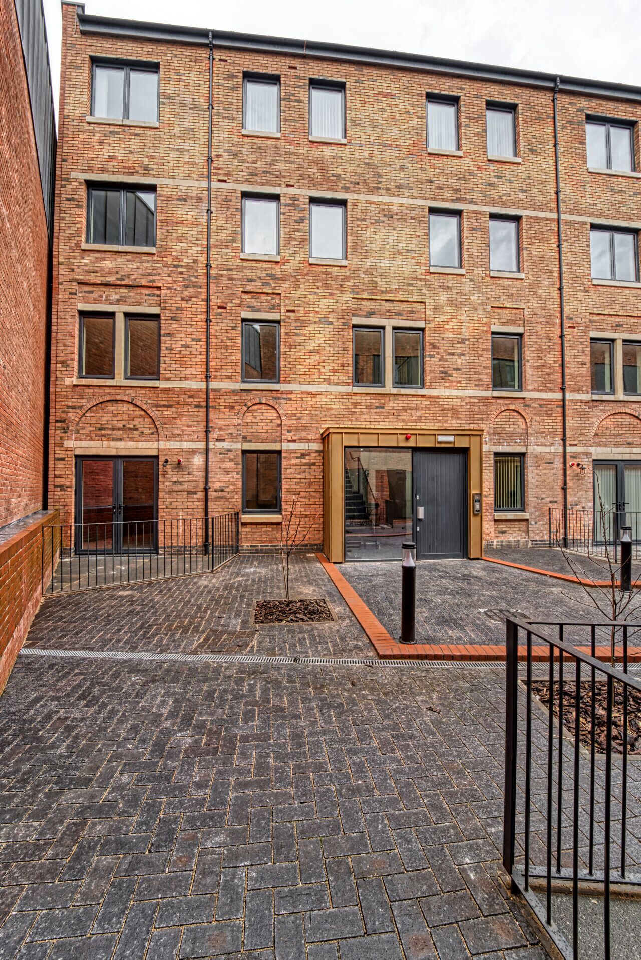 A multi-story brick building with a courtyard.