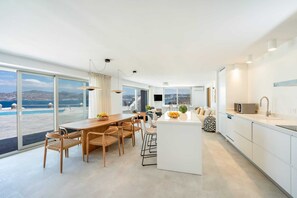 Enjoy meals in the spacious dining area with a view of the coastal landscape.