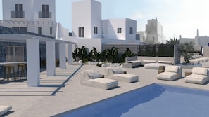 Relax by the pool surrounded by comfortable lounge chairs and sofas.