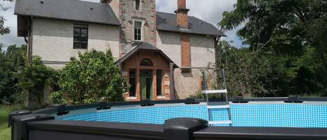 A large house with a swimming pool in the backyard.