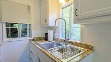 Fridge, microwave, coffee/tea maker, cookware/dishes/utensils