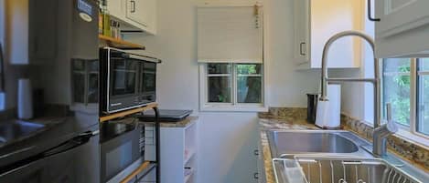 Fridge, microwave, coffee/tea maker, cookware/dishes/utensils