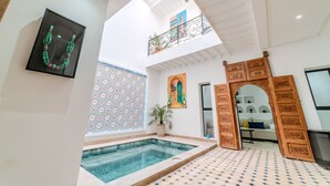 A spacious indoor pool area with a high ceiling and a balcony. - Riad Dar Amarena - Exclusif - BreakFast (Marrakech)