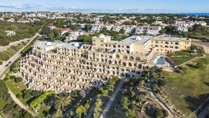 An aerial view of a residential area with a large building complex featuring multiple domed structures and a central courtyard. - Casa Colina Sol 611 - Seaview apartment (Carvoeiro)