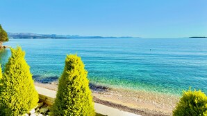 A clear view of a beach with calm waters and distant mountains. - Beach Villa Smile with private pool (Barbati)