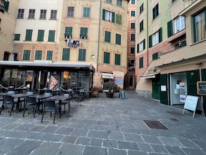 Experience the charm of a traditional urban square, surrounded by historic buildings and quaint establishments.