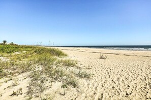 Enjoy a serene beach experience with gentle waves and lush surroundings.