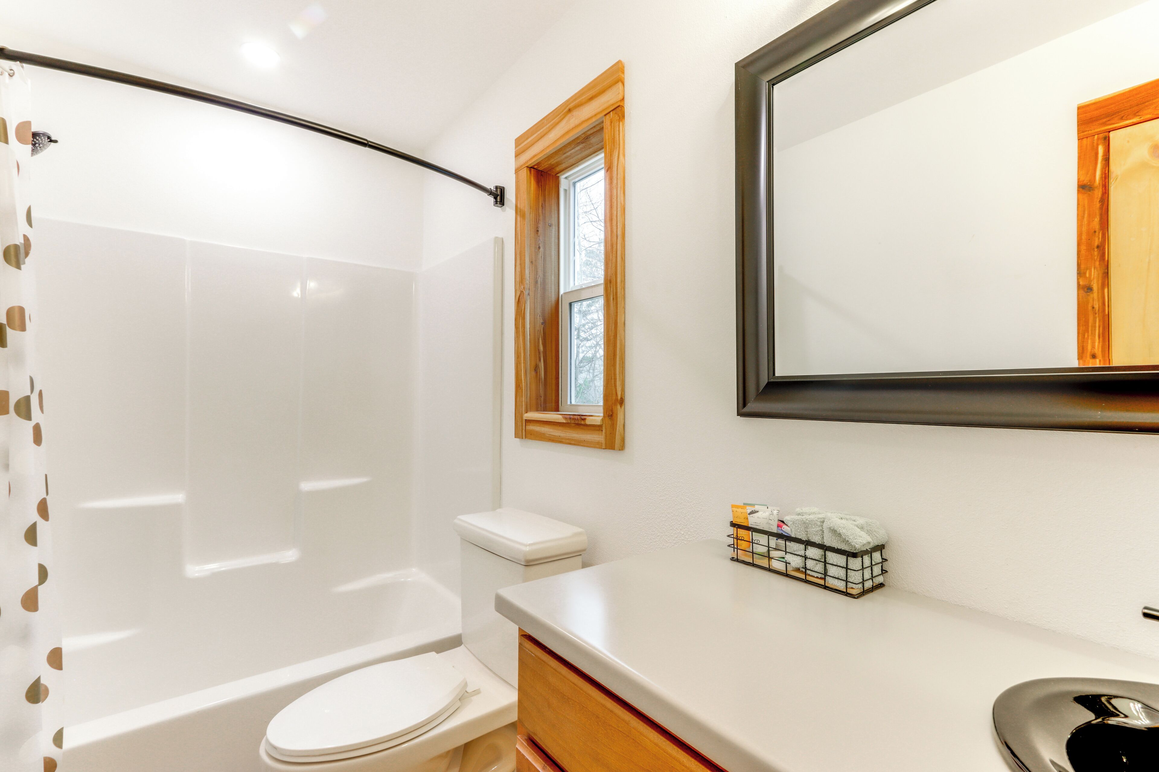 A bathroom with a shower, toilet, and sink.