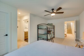 A bedroom with bunk beds, a ceiling fan, a staircase, and a clear chair. - 13 Mi to Boulder: Family-friendly Home in Erie! (Erie)