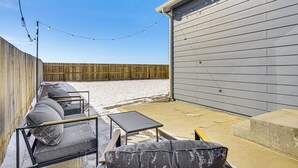 A patio with outdoor furniture, a concrete step, and a wooden fence. - Hike, Sightsee & Explore: Home in Colorado Springs (Colorado Springs)