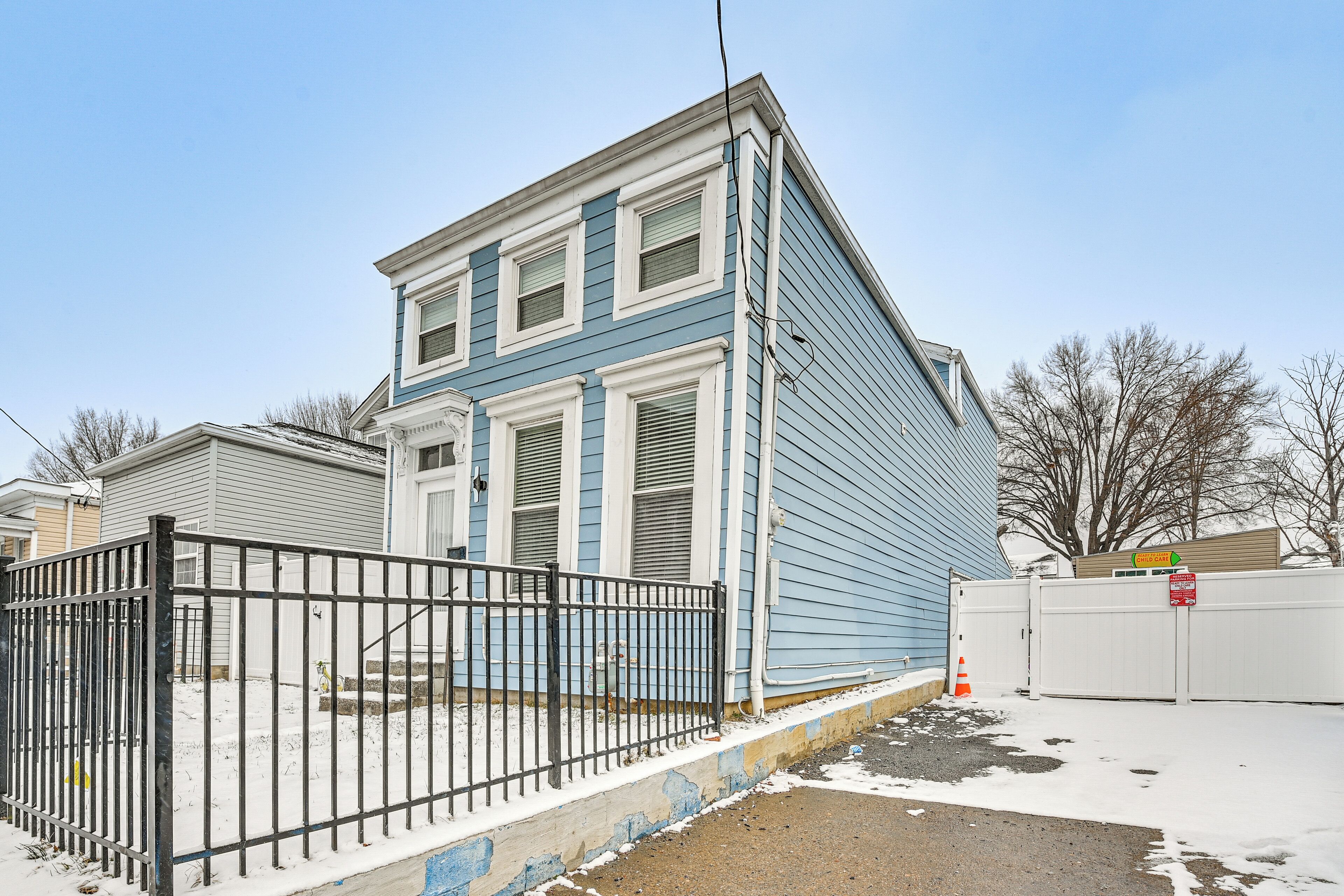 A two-story building with a blue exterior and white trim.