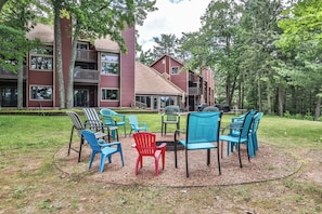 A building with multiple balconies and a patio area with outdoor seating.