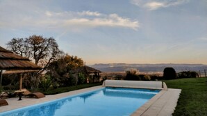 A swimming pool with a view of mountains in the background.