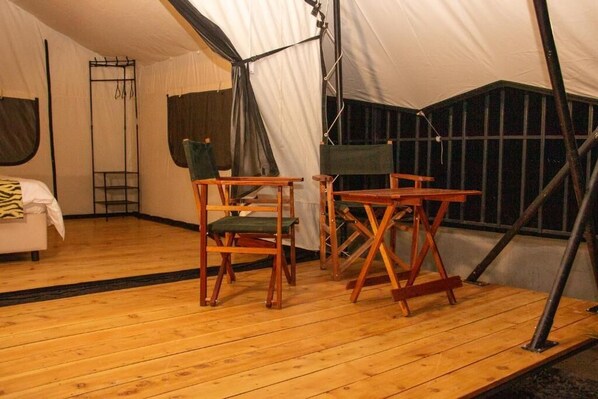 A tent with a wooden floor, two wooden chairs, a small table, and a ladder. - Ayza Elementaita (Gilgil)