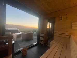 Relax in a cozy space with a panoramic view, featuring a seating area and a natural ambiance.