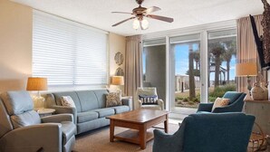 A living room with a sofa, armchairs, a coffee table, and a ceiling fan. - Beach Club Bristol 101 3 Bedroom Condo (Gulf Shores)