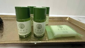 Three bottles of Eden conditioning shampoo and a bar of Eden soap on a tray.